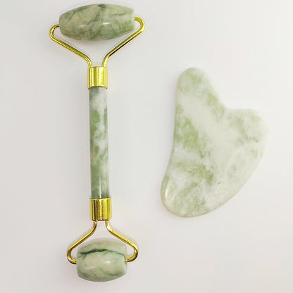 White jade facial roller in use on cheek for gentle massage
